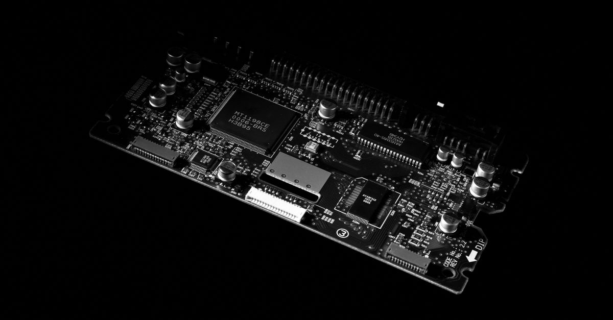 Detailed black and white image of a computer circuit board, showcasing technology components.